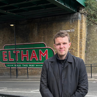 Charlie by the Eltham sign at Eltham Station